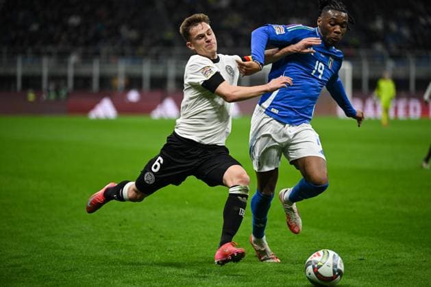 Joshua Kimmich of Germany and Destiny Udogie of Italy during the UEFA NATIONS LEAGUE 2025 match between Italy and Germany, round of quarter finals first leg match, on 20 of March 2025 at Giuseppe Meazza San Siro Siro stadium in Milan, Italy. Photo Tiziano Ballabio  Copyright: xTizianoxBallabio IPAxSportx xipa-agency.netx xx IPA_55559413 IPA_Agency_IPA55559413