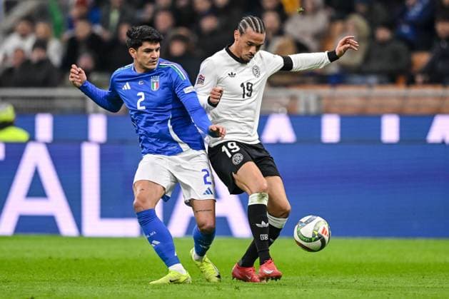 Roul Bellanova (Italy) und Leroy Sane (Germany) battle for the ball during the UEFA Nations League quarterfinal leg one match between Italy and Germany at Stadio San Siro on March 20, 2025 in Milan, Italy. (Photo by Harry Langer DeFodi Images)