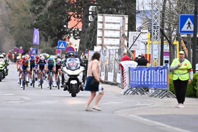 Bredene Koksijde Classic 2025 cycling race KOKSIJDE, BELGIUM - MARCH 21 : a woman crossing the street during the Men Elite UCI 1.Pro 23rd Bredene Koksijde Classic cycling race with start in Bredene and finish in Koksijde (201 km) on March 21, 2025 in Koksijde, Belgium, 21 03 2025 ( Motordriver Stephan Boone & Koksijde Belgium  Copyright: xTomasxSiskx