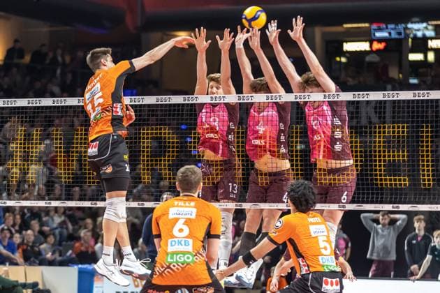 23.03.2025, Berlin, Volleyball: 1.Bundesliga, Maenner, Playoffs, Viertelfinale, 1. Spieltag, BR Volleys - Energiequelle Netzhoppers KW, Max-Schmeling-Halle. Berlins Moritz Reichert (l-r) spielt den Ball gegen den Block aus Charlie Peters, Odin Gnilitza und Lovis Homberg von Netzhoppers KW. BR Volleys - Netzhoppers KW