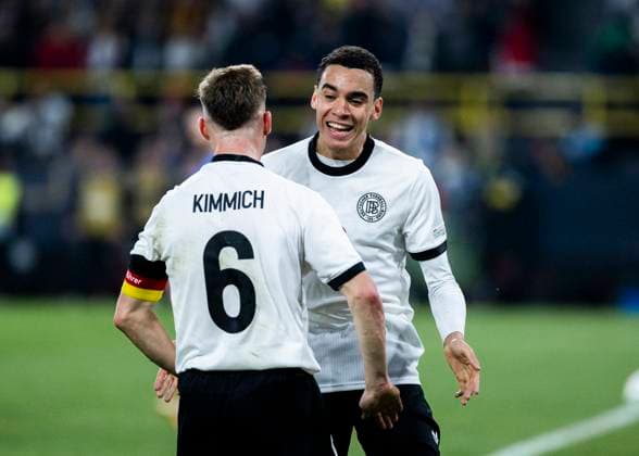 Signal-Iduna-Park, Dortmund, 23.03.2025: Jamal Musiala of Germany (R) celebrates scoring the 2:0 goal with Joshua Kimmich of Germany during the UEFA Nations League Quarterfinal Match Germany v Italia.