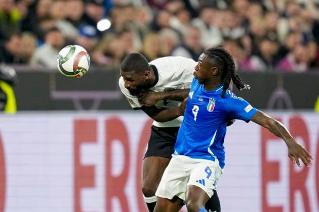 Antonio Ruediger (Germany) un d Moise Kean (Italy) battle for the ball during the UEFA Nations League Quarterfinal Leg Two match between Germany and Italy at Football Stadium Dortmund on March 23, 2025 in Dortmund, Germany.