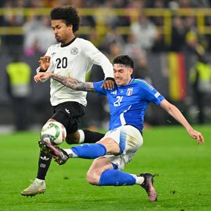 (250324) -- DORTMUND, March 24, 2025 -- Karim Adeyemi (L) of Germany vies with Alessandro Bastoni of Italy during the UEFA Nations League quarterfinal 2nd leg football match between Germany and Italy in Dortmund, Germany, March 23, 2025. (Photo by Ulrich Hufnagel Xinhua) (SP)GERMANY-DORTMUND-FOOTBALL-UEFA NATIONS LEAGUE-GERMANY VS ITALY WuxErlixi¡¤hufunageer 