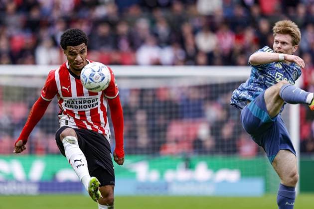 EINDHOVEN, 30-03-2025, Philips Stadium, Dutch Eredivisie Football season 2024 2025 , match between PSV and Ajax. Ajax player Oliver Edvardsen and PSV player Malik Tillman PSV - Ajax  x28532409x Copyright: