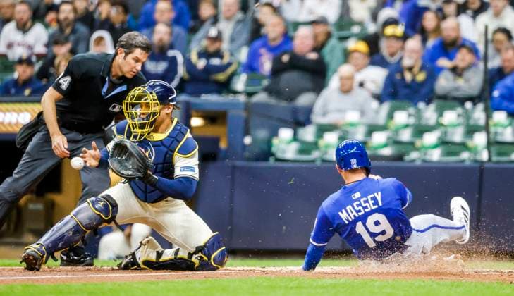 Kansas City Royals second baseman Michael Massey (R) scores on a base hit by Kansas City Royals second baseman Cavan Biggio as Milwaukee Brewers catcher William Contreras (L) waits for the throw from the outfield in the second inning of the MLB, Baseball Herren, USA baseball game between the Kansas City Royals and the Milwaukee Brewers at American Family Field in Milwaukee, Wisconsin on Wednesday, April 02, 2025. Home plate umpire John Tupane watches the play.  MIL20250402805 TANNENxMAURY