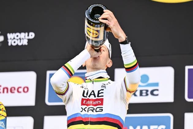 Slovenian Tadej Pogacar of UAE Team Emirates celebrates on the podium with champagne after winning the men s race of the Ronde van Vlaanderen Tour des Flandres Tour of Flanders one day cycling race, 268,9km from Brugge to Oudenaarde, Sunday 06 April 2025. ERICxLALMAND  x119657947x