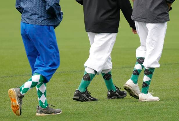 Patrons wear argyle socks and knickers on the course before play is suspended due to lightning and thunderstorms in the area during a practice round leading up the Masters Tournament at Augusta National Golf Club in Augusta, Georgia on Monday, April 7, 2025.  AUG20250407114 JOHNxANGELILLO