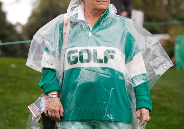 A patron wears a plastic poncho on the course before play is suspended due to lightning and thunderstorms in the area during a practice round leading up the Masters Tournament at Augusta National Golf Club in Augusta, Georgia on Monday, April 7, 2025.  AUG20250407121 JOHNxANGELILLO