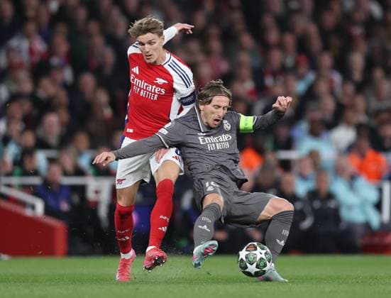 London, England, 8th April 2025. Martin Odegaard of Arsenal tackles Luka Modric of Real Madrid during the Arsenal vs Real Madrid UEFA Champions League match at the Emirates Stadium, London. Picture credit should read: David Klein Sportimage EDITORIAL USE ONLY. No use with unauthorised audio, video, data, fixture lists, club league logos or live services. Online in-match use limited to 120 images, no video emulation. No use in betting, games or single club league player publications. SPI_033_DK_Arsenal_Real_Madrid SPI-3819-0035