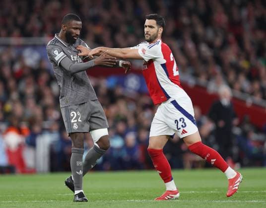 London, England, 8th April 2025. Mikel Merino of Arsenal clashes with Antonio Rudiger of Real Madrid during the Arsenal vs Real Madrid UEFA Champions League match at the Emirates Stadium, London. Picture credit should read: David Klein Sportimage EDITORIAL USE ONLY. No use with unauthorised audio, video, data, fixture lists, club league logos or live services. Online in-match use limited to 120 images, no video emulation. No use in betting, games or single club league player publications. SPI_041_DK_Arsenal_Real_Madrid SPI-3819-0046