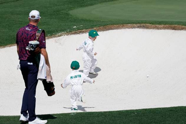 Taylor Pendrith watches as his son Hayes plays in a sand trap with another boy during the 2025 Masters Par 3 Contest at Augusta National Golf Club in Augusta, Georgia, on Wednesday, April 9, 2025. The 2025 Masters Golf tournament begins on Thursday, April 10.  AUG20250409864 JOHNxANGELILLO