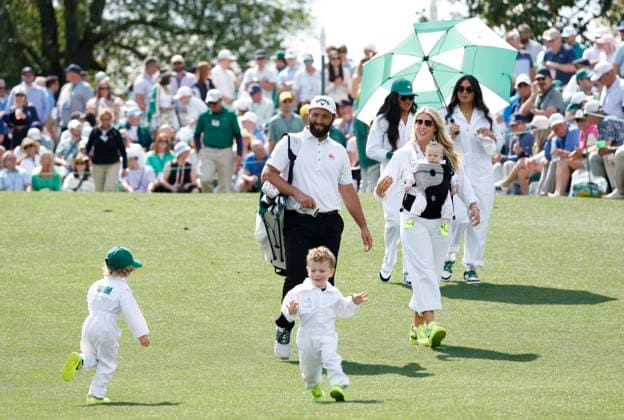 Jon Rahm of Spain walks with his wife Kelley Cahill and their children Kepa, Eneko and Alaia during the 2025 Masters Par 3 Contest at Augusta National Golf Club in Augusta, Georgia, on Wednesday, April 9, 2025. The 2025 Masters Golf tournament begins on Thursday, April 10.  AUG20250409872 JOHNxANGELILLO