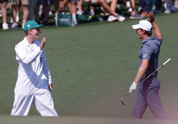 Maverick McNealy celebrates with his caddie Scout McNealy after chipping into the cup for a birdie on the second hole during the first round of the Masters golf tournament at Augusta National Golf Club in Augusta, Georgia on Thursday, April 10, 2025.  AUG20250410554 TANNENxMAURY