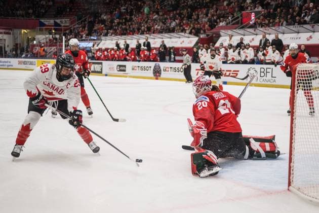Marie-Philip Poulin of Canada, left, and goalkeeper Andrea Braendli of Switzerland in action during the Ice hockey, Eishockey IIHF Women s World Championship, WM, Weltmeisterschaft Group A, match Switzerland vs Canada, Ceske Budejovice, Czech Republic, April 11, 2025. (CTKxPhoto PetrxSkrivanek) CTKPhotoP2025041106484 CTKPhotoP2025041106484