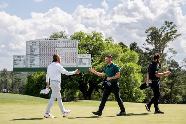 250411 Tommy Fleetwood of England, Wyndham Clark of the United States and Jon Rahm of Spain on the 18th green during the second round of the 2025 Masters Golf Tournament on April 11, 2025 in Augusta. Photo: Petter Arvidson BILDBYRAN kod PA PA1008 bbeng golf masters the masters augusta us masters Copyright: PETTERxARVIDSON BB250411PA114
