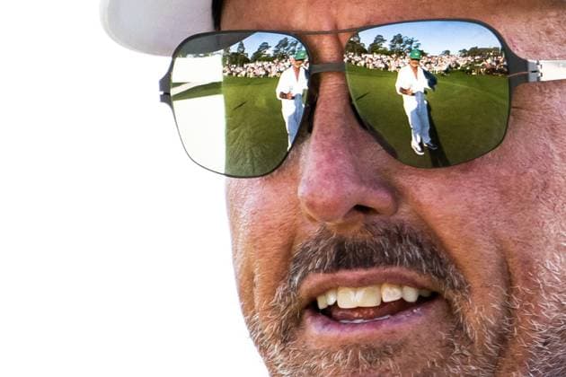 250411 Caddie Jon Yarbrough is seen through a reflection from Phil Mickelson of the United States sunglasses during the second round of the 2025 Masters Golf Tournament on April 11, 2025 in Augusta. Photo: Petter Arvidson BILDBYRAN kod PA PA1008 bbeng golf masters the masters augusta us masters Copyright: PETTERxARVIDSON BB250411PA227