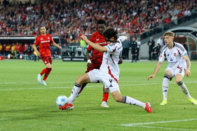 12.04.2025, xmohx, Fussball 2.Bundesliga, 1.FC Kaiserslautern - 1.FC Nürnberg v.l. Ragnar Ache (1. FC Kaiserslautern) Fabio Gruber (1.FC Nuernberg) Zweikampf, Aktion, action, battle for the ball (DFL DFB REGULATIONS PROHIBIT ANY USE OF PHOTOGRAPHS as IMAGE SEQUENCES and or QUASI-VIDEO) Kaiserslautern