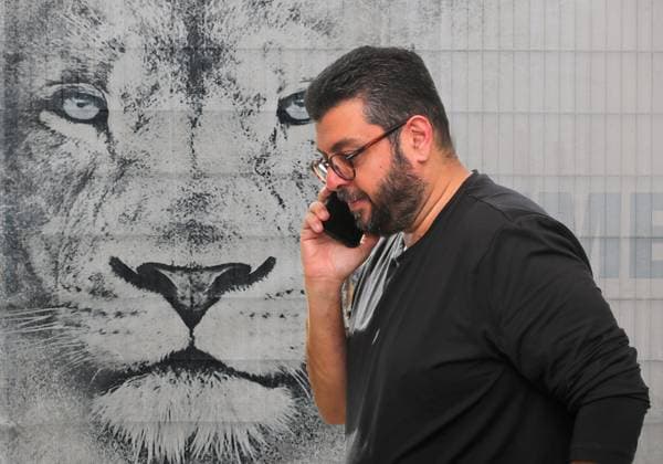 ! ACHTUNG FOTOMONTAGE ! Hier im Bild Hasan Ismaik mit Telefon, beim Telefonieren mit Handy, der angeblich bereit wäre, seine Anteile am TSV 1860 München zu verkaufen, falls sich ein Käufer finden lässt. im Hintergrund der Löwenkopf am Trainingsgelände