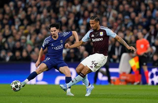Birmingham, England, 15th April 2025. Vitinha of Paris St Germain and Aston Villa s Boubacar Kamara during the Aston Villa vs Paris Saint Germain Quarter Final 2nd Leg UEFA Champions League match at Villa Park, Birmingham. Picture credit should read: Andrew Yates Sportimage EDITORIAL USE ONLY. No use with unauthorised audio, video, data, fixture lists, club league logos or live services. Online in-match use limited to 120 images, no video emulation. No use in betting, games or single club league player publications. SPI_043_AY_Villa_PSG SPI-3842-0043