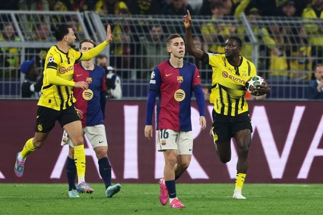 (250416) -- DORTMUND, April 16, 2025 -- Serhou Guirassy (1st R) of Borussia Dortmund celebrates scoring with his teammate Ramy Bensebaini (1st L) during the UEFA Champions League quarterfinal 2nd leg football match between Borussia Dortmund and FC Barcelona, Barca in Dortmund, Germany, April 15, 2025. (Photo by Xinhua) (SP)GERMANY-DORTMUND-FOOTBALL-UEFA CHAMPIONS LEAGUE-DORTMUND VS BARCELONA JoachimxBywaletz 
