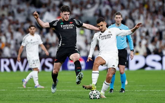 Declan Rice of Arsenal and Dani Ceballos of Real Madrid in action Real Madrid v Arsenal, UEFA Champions League, Quarter-Finals, 2nd Leg, Football, Santiago Bernabu Stadium, Madrid, Spain - 16 Apr 2025 EDITORIAL USE ONLY No use with unauthorised audio, video, data, fixture lists, club league logos or live services. Online in-match use limited to 120 images, no video emulation. No use in betting, games or single club league player publications.  Copyright: xRubenxAlbarran Shutterstockx 15253938da