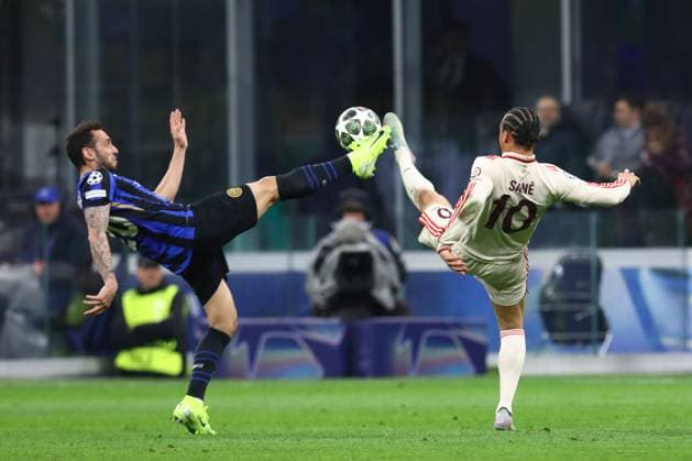 April 16, 2025, Milan, Lombardy, Italy: HAKAN CALHANOGLU 20 of Inter and LEROY SANE 10 of Bayern fight for the ball in the UEFA 2024 25 Quarter-Final second leg game between FC INTER and BAYERN MUNICH at the San Siro stadium in Milan, Italy Milan Italy - ZUMAc179 20250416_zep_c179_003 Copyright: xMickaelxChavetx