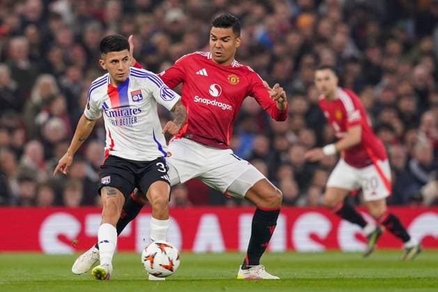 Manchester, England, 17th April 2025. Thiago Almada of Lyon and Casemiro of Manchester United, ManU battle for the ball during the Manchester United vs Olympique Lyonnais Quarter Final 2nd Leg UEFA Europa League match at Old Trafford, Manchester. Picture credit should read: Andrew Yates Sportimage EDITORIAL USE ONLY. No use with unauthorised audio, video, data, fixture lists, club league logos or live services. Online in-match use limited to 120 images, no video emulation. No use in betting, games or single club league player publications. SPI_038_AY_MANCHESTER_UNITED_V_OLYMPIQUE_LYONNAIS SPI-3844-0029