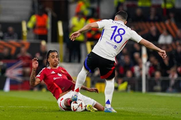 Manchester, England, 17th April 2025. Rayan Cherki of Lyon is tackled by Leny Yoro of Manchester United, ManU during the Manchester United vs Olympique Lyonnais Quarter Final 2nd Leg UEFA Europa League match at Old Trafford, Manchester. Picture credit should read: Andrew Yates Sportimage EDITORIAL USE ONLY. No use with unauthorised audio, video, data, fixture lists, club league logos or live services. Online in-match use limited to 120 images, no video emulation. No use in betting, games or single club league player publications. SPI_064_AY_MANCHESTER_UNITED_V_OLYMPIQUE_LYONNAIS SPI-3844-0044