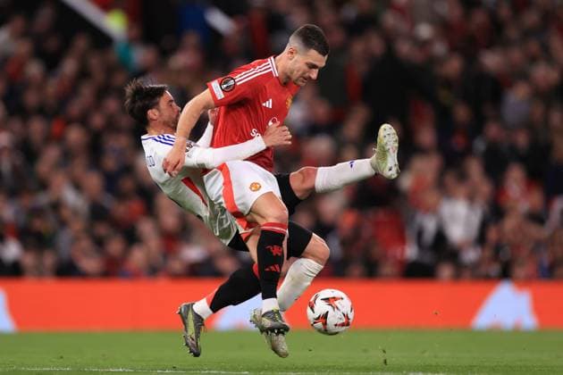 Manchester United, ManU v Olympique Lyonnais 17 April 2025 - UEFA Europa League - Quarter Final (2nd Leg) - Manchester United v Olympique Lyonnais - Diogo Dalot of Manchester United is challenged by Nicolas Tagliafico of Olympique Lyonnais - Photo: Simon Stacpoole Offside. Manchester UK Copyright: xSimonxStacpoolexOffside