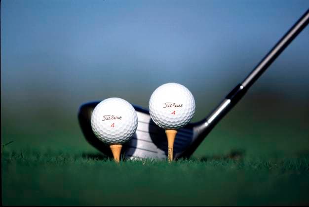 Ball and tee equipment photoshoot Two balls, one driver aiming for the perfect shot under the clear blue sky on a tee Copyright: xMarkxNewcombex
