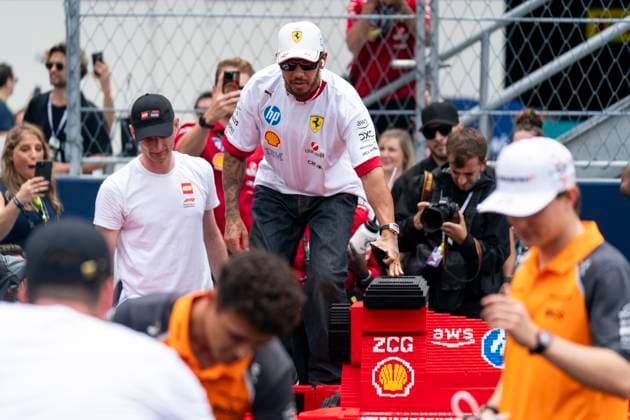 British Formula One driver Lewis Hamilton of Scuderia Ferrari jumps in a Lego car during the divers parade at the Formula One Miami Grand Prix at the Miami International Autodrome in Miami Gardens, Florida on Sunday, May 4, 2025.  MIA2025050433 GREGxNASH