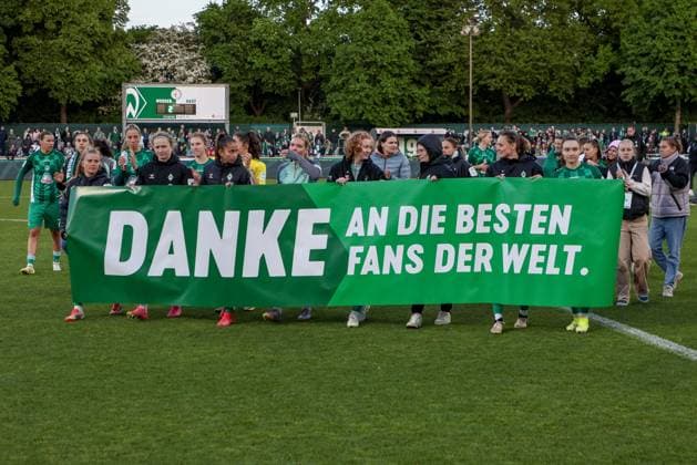 Spielerinnen des SV Werder Bremen bedanken sich bei den Fans für die Unterstützung in dieser Saison und zeigen ein Transparent mit der Aufschrift, dem Text Danke an die besten Fans der Welt, DIE DFB-RICHTLINIEN UNTERSAGEN JEGLICHE NUTZUNG VON FOTOS ALS SEQUENZBILDER UND ODER VIDEOÄHNLICHE FOTOSTRECKEN. DFB REGULATIONS PROHIBIT ANY USE OF PHOTOGRAPHS AS IMAGE SEQUENCES AND OR QUASI-VIDEO., 04.05.2025, Bremen (Deutschland), Fussball, Google Pixel Frauen-Bundesliga, SV Werder Bremen - 1. FC Köln