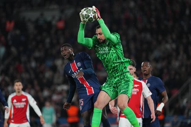 Gianluigi Donnarumma of PSG gathers under pressure from teammate Nuno Mendes of PSG Paris Saint-Germain v Arsenal, UEFA Champions League, Semi Final, Second Leg, Football, Parc des Princes, Paris, France - 07 May 2025 EDITORIAL USE ONLY No use with unauthorised audio, video, data, fixture lists, club league logos or live services. Online in-match use limited to 120 images, no video emulation. No use in betting, games or single club league player publications.  Copyright: xDavexWinter Shutterstockx 15288067bk