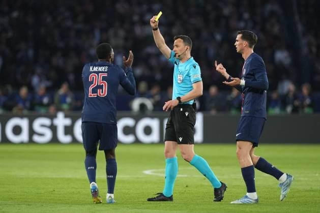 Referee Felix Zwayer gives a yellow card to Nuno Mendes of PSG Paris Saint-Germain v Arsenal, UEFA Champions League, Semi Final, Second Leg, Football, Parc des Princes, Paris, France - 07 May 2025 EDITORIAL USE ONLY No use with unauthorised audio, video, data, fixture lists, club league logos or live services. Online in-match use limited to 120 images, no video emulation. No use in betting, games or single club league player publications.  Copyright: xDavexWinter Shutterstockx 15288067hk