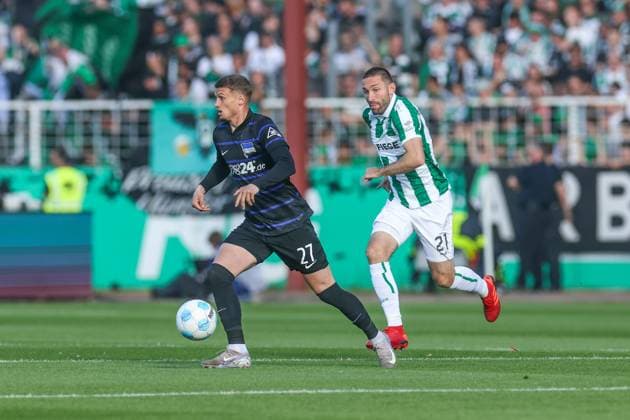 09.05.2025, Fussball, Saison 2024 2025, 2. Bundesliga, 33. Spieltag, Preussen Münster - Hertha BSC, v. l. Michael Cuisance (Hertha BSC), Rico Preißinger (Preußen Münster) Münster LVM Arena NRW Deutschland xRHR-FOTO TRx