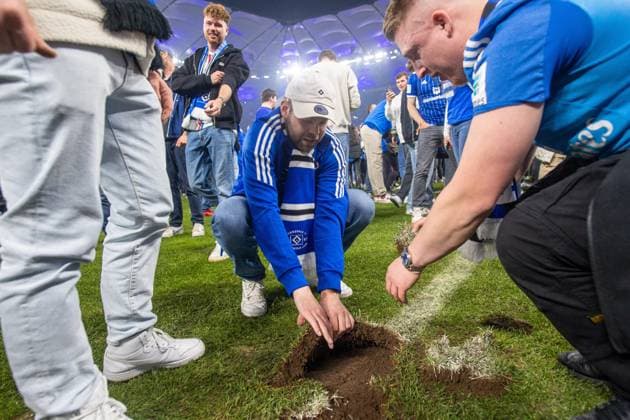 Fussball, Herren, Saison 2024 2025, 2. Bundesliga (33. Spieltag), Hamburger SV - SSV Ulm, der HSV feiert den Aufstieg in die 1. Bundesliga, im Bild: Platzsturm der Fans, einige nehmen sich Rasenstücke mit nach Hause, 10.05. 2025,