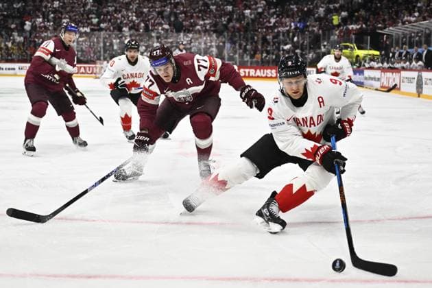 STOCKHOLM, SWEDEN 20250511 Canada s Nate MacKinnon (R) and Latvia s Kristaps Roberts Zile during the IIHF Ice hockey, Eishockey World Championship, WM, Weltmeisterschaft group A match between Latvia and Canada at Avicii Arena in Stockholm, Sweden, on May 11, 2025. STOCKHOLM SWEDEN x10430x