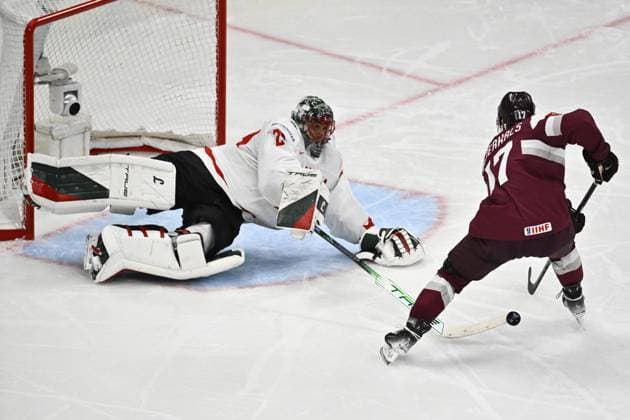 STOCKHOLM, SVERIGE 20250511 Latvia s Martins Dzierkals against Canada s goal keeper Marc-Andre Fleury during the IIHF Ice hockey, Eishockey World Championship, WM, Weltmeisterschaft group A match between Latvia and Canada at Avicii Arena in Stockholm, Sweden, on May 11, 2025. STOCKHOLM SVERIGE x10430x