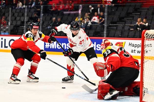 Austria s Marco Kasper, Canada s Barrett Hayton and Austria s goalkeeper Florian Vorauer during the IIHF Ice hockey, Eishockey World Championship, WM, Weltmeisterschaft group A match between Canada and Austria at Avicii Arena in Stockholm, Sweden, on May 15, 2025. STOCKHOLM SWEDEN x10040x