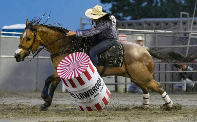 (250517) -- SURREY, May 17, 2025 -- A rider competes in the ladies barrel racing competition at the Cloverdale Rodeo and Country Fair in Surrey, British Columbia, Canada, May 16, 2025. As one of the largest rodeos in Canada, the annual Cloverdale Rodeo and Country Fair kicked off here on Friday. (Photo by Xinhua) (SP)CANADA-SURREY-CLOVERDALE RODEO LiangxSen 