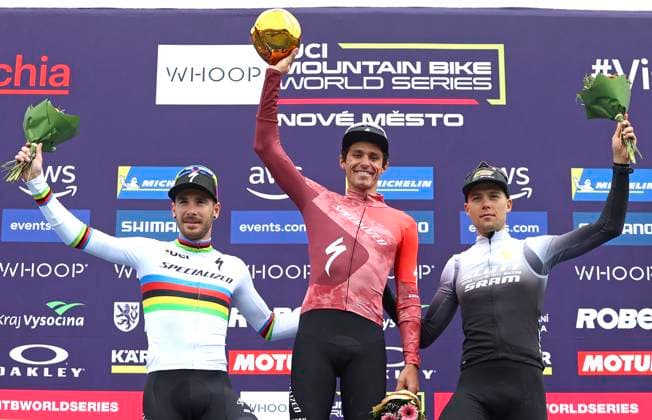 From left second Victor Koretzky of France and winner Christopher Blevins of USA and third Filippo Colombo on podium after the short track during the Mountain bike cross country World Cup event, Nove Mesto na Morave, Czech Republic, May 24, 2025. (CTKxPhoto LiborxPlihal) CTKPhotoP2025052402481  CTKPhotoP2025052402481
