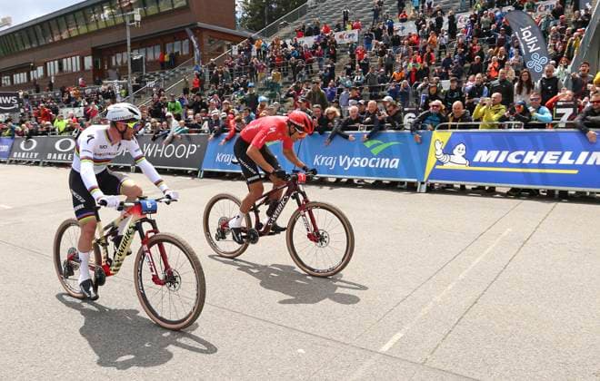 From left Victor Koretzky of France and Christopher Blevins of USA compete during the short track during the Mountain bike cross country World Cup event, Nove Mesto na Morave, Czech Republic, May 24, 2025. (CTKxPhoto LiborxPlihal) CTKPhotoP2025052402637  CTKPhotoP2025052402637