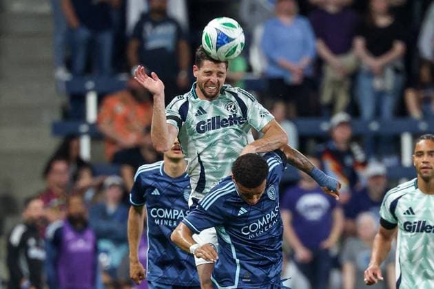 May 24, 2025: New England Revolution midfielder Matt Polster (8) heads the ball over Sporting Kansas City defender Logan Ndenbe (18) during the second half at Childrens Mercy Park in Kansas City, KS. CSM Kansas City United States of America - ZUMAc04_ 20250524_zma_c04_421 Copyright: xDavidxSmithx