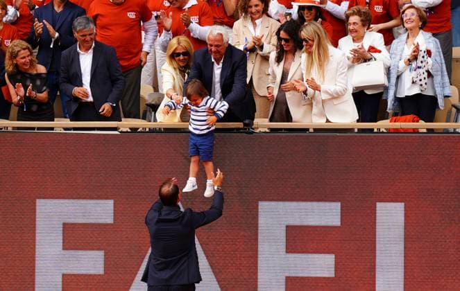 Rafa Nadal is honoured in a farewell ceremony on Philippe Chatrier Court and does a lap of honour on the famous court past his parents, his wife, sister and grandmothers as his son is lowered to him French Open Tennis, Day One, Tennis, Roland Garros, Paris, France - 25 May 2025 EDITORIAL USE ONLY No use with unauthorised audio, video, data, fixture lists, club league logos or live services. Online in-match use limited to 120 images, no video emulation. No use in betting, games or single club league player publications.  Copyright: xJavierxGarcia Shutterstockx 15314618ca