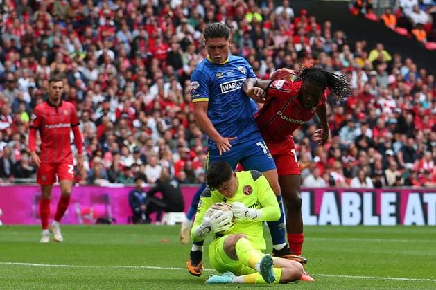 26th May 2025; Wembley Stadium, London, England; EFL League Two Play Off Football Final, AFC Wimbledon versus Walsall; goalkeeper Tommy Simkin of Walsall beats his teammate Nathan Asiimwe and Mathew Stevens of AFC Wimbledon to the ball  ActionPlus12794723 KatiexChan