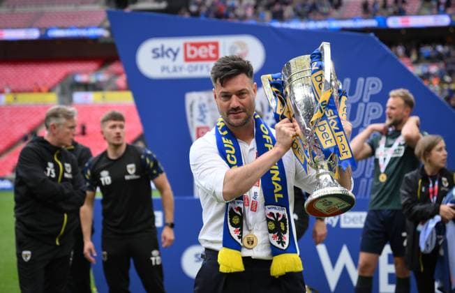 Football - 2024 2025 EFL Sky Bet League Two - Play-Offs - Final - AFC Wimbledon vs Walsall - Wembley Stadium - Monday 26th May 2025. AFC Wimbledon s Manager Johnnie Jackson with the trophy after clinching promotion. COLORSPORT Ashley Western 