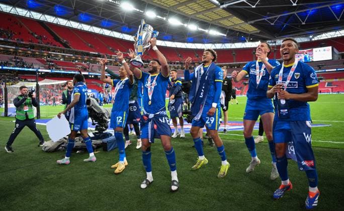 Football - 2024 2025 EFL Sky Bet League Two - Play-Offs - Final - AFC Wimbledon vs Walsall - Wembley Stadium - Monday 26th May 2025. AFC Wimbledon s Ryan Johnson with the trophy after their promotion to League One. COLORSPORT Ashley Western 