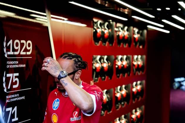 BARCELONA - Lewis Hamilton (Ferrari) shields his face from the press in attendance upon arrival at the Circuit de Barcelona-Catalunya for the media day leading up to the Spanish Grand Prix. ANP SANDER KING xVIxANPxSportx xxANPxIVx 528948708 originalFilename: 528948708.jpg
