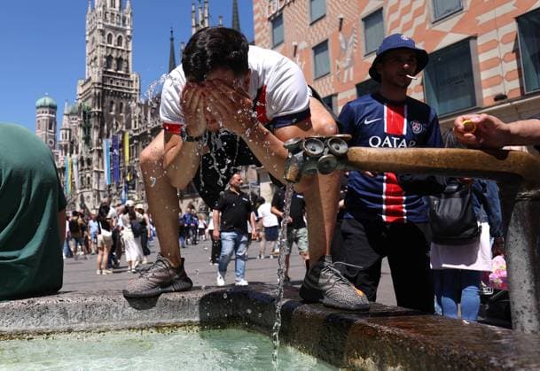 UCL Final Previews 31 May 2025, Munich - UEFA Champions League Final Previews - A PSG fan wets his face and neck with water from a public fountain to combat the hot weather - Photo: Charlotte Wilson Offside. Munich Germany Copyright: xCharlottexWilsonx xOffsidexOffside