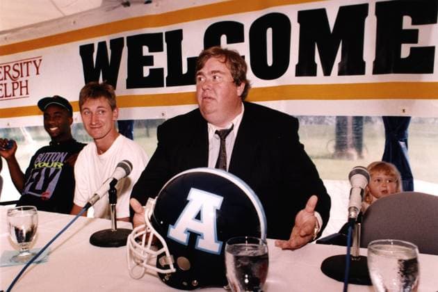 June 7, 1991, Guelph, On, Canada: Toronto Argonauts co-owners John Candy, right, and Wayne Gretzky along with player Raghib (Rocket) Ismail talk to reporters at the team s training camp in Guelph, Ont., June 7, 1991. Canada News - June 7, 1991  - ZUMAc35_ 19910607_zaf_c35_001 Copyright: xHansxDerykx